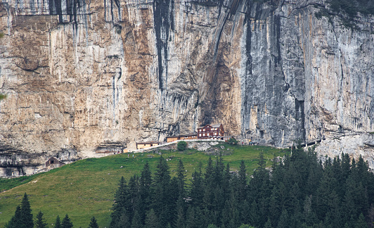 chapel st. michael, wildkirchli switzerland appenzell, the building was rebuilt as a restaurant which is located steeply on the slope is now a popular tourist spot, sometimes you can not find a seat to eat and drink