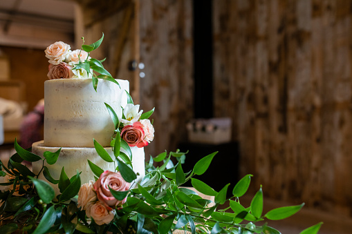 A shot of a decorated wedding cake, it is ready to be sliced and for wedding guests to enjoy in Cumbria, England.