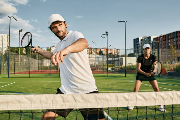 doubles team of tennis players while playing tennis match. tennis teamwork - doubles imagens e fotografias de stock