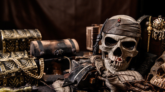 Pirate with human skull. Treasure chest and gold. Discovery equipment and explorer for disappear fortune.