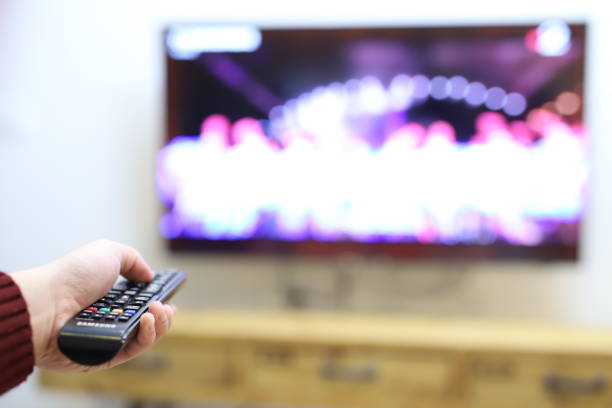 istock use the remote control to change channels on Television 1338693937