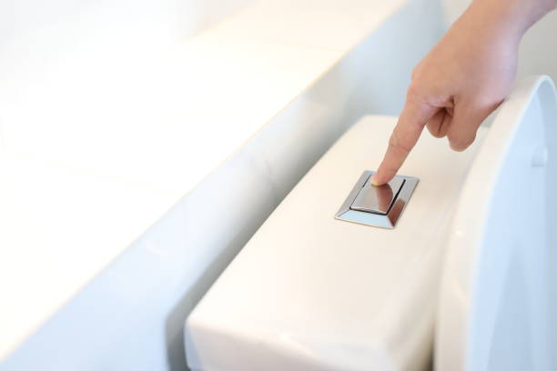 istock Pushing the toilet button and using the toilet for good hygiene 1338694492