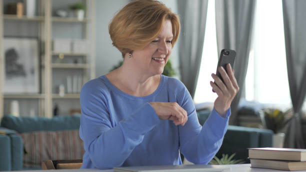 istock Online Video Chat on Smartphone by Relax Man 1338694623