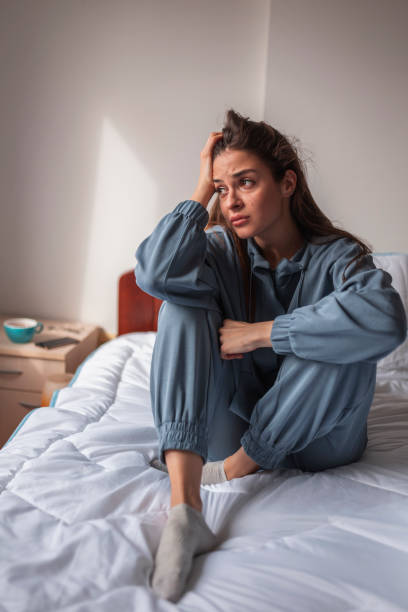 istock Upset woman sitting in bed 1338695363