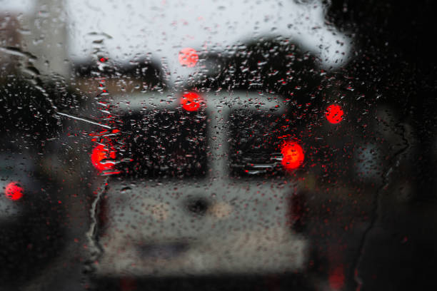 istock Blurred colored lights through the car window with raindrops. 1338696958