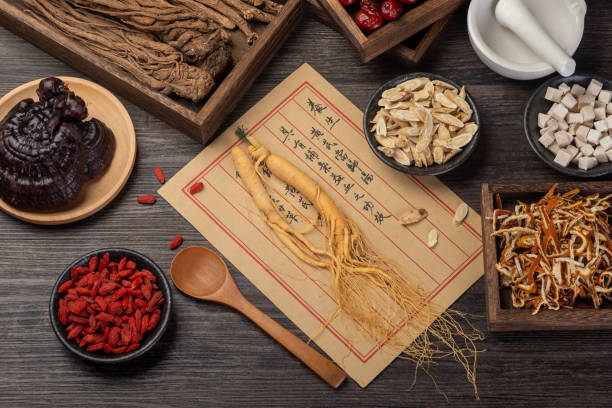 istock Ancient Chinese medicine books and herbs on the table 1338700336