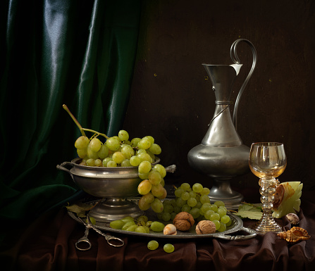 Still life with vintage silver items, fresh ripe fruit