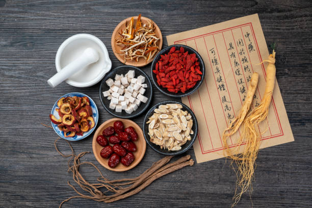 istock Ancient Chinese medicine books and herbs on the table 1338700525