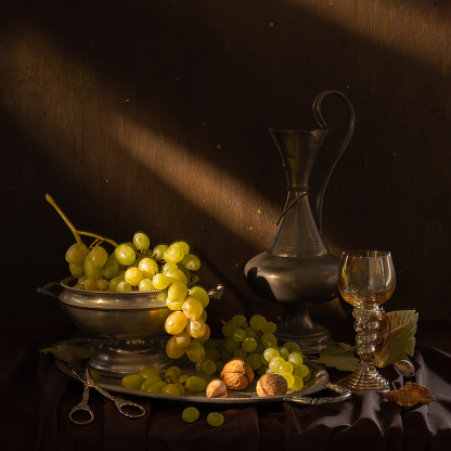 Still life with vintage silver items, fresh ripe fruit