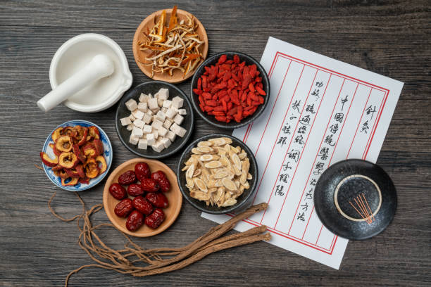 istock Ancient Chinese medicine books and herbs on the table 1338700558