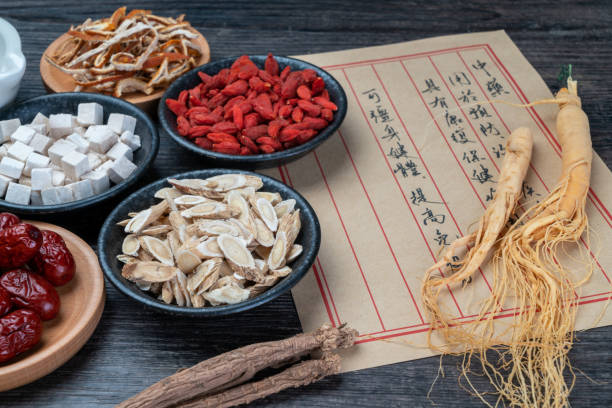 istock Ancient Chinese medicine books and herbs on the table 1338700564