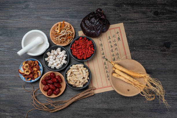 istock Ancient Chinese medicine books and herbs on the table 1338700616