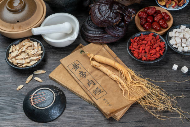 istock Ancient Chinese medicine books and herbs on the table 1338700671