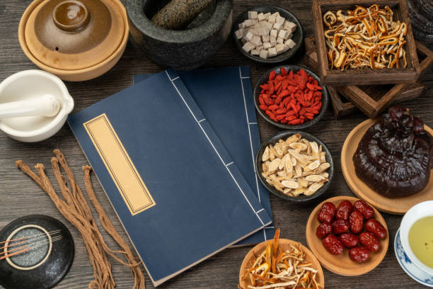 istock Ancient Chinese medicine books and herbs on the table 1338700819