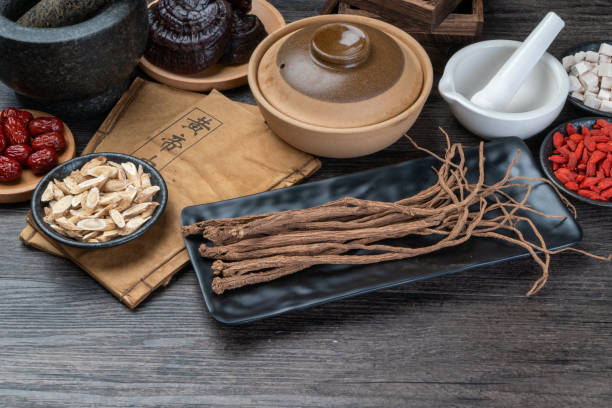 istock Ancient Chinese medicine books and herbs on the table 1338701076