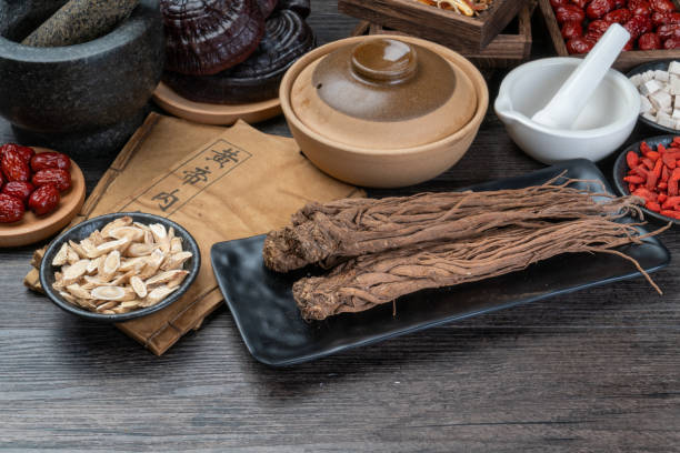 istock Ancient Chinese medicine books and herbs on the table 1338701080