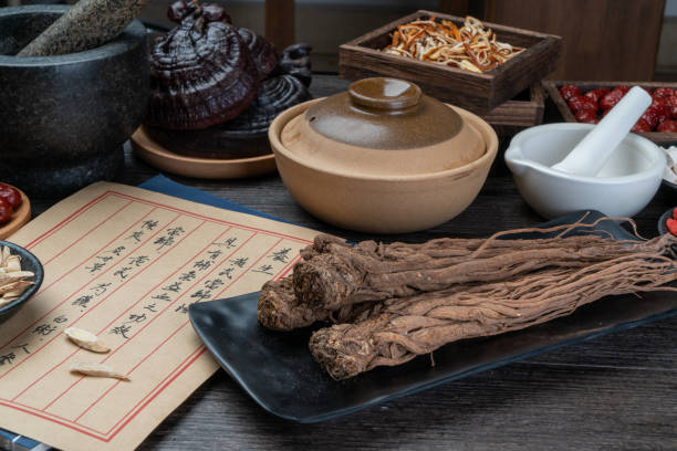 istock Ancient Chinese medicine books and herbs on the table 1338701643