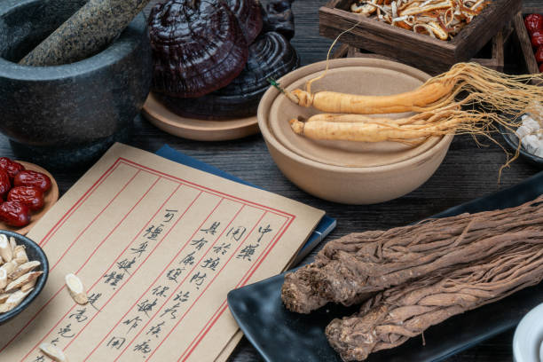 istock Ancient Chinese medicine books and herbs on the table 1338701663