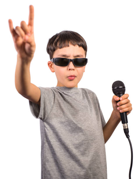 istock Cute boy posing as a rockstar on white background 1338701710