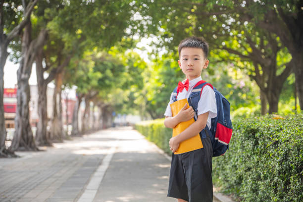 istock A pupil with a book in his hand 1338701745