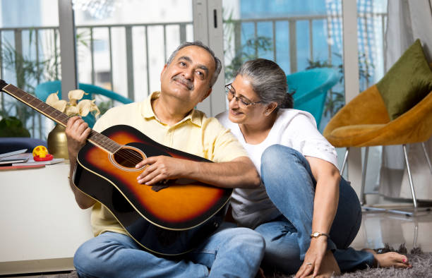 istock Couple having fun playing guitar at home 1338701764