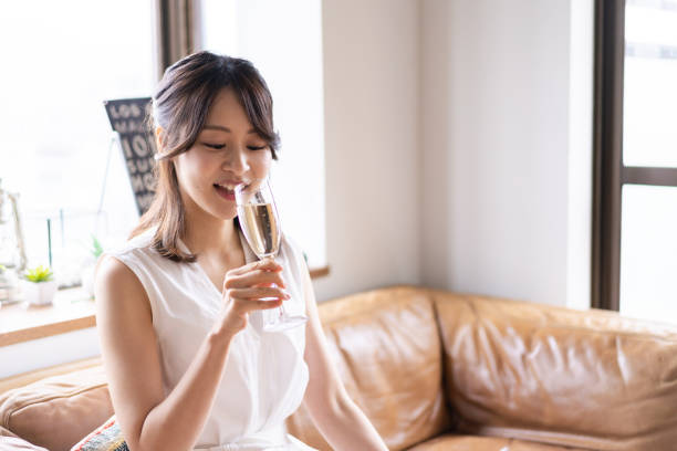 istock Young woman drinking sparkling wine 1338703038