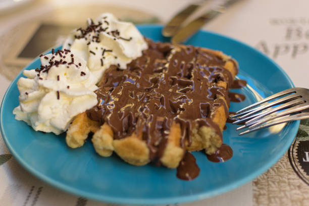 istock Delicious waffle with chocolate and cream 1338704286
