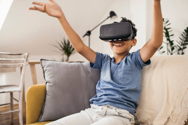 istock Boy playing with a virtual reality headset at home 1338704856
