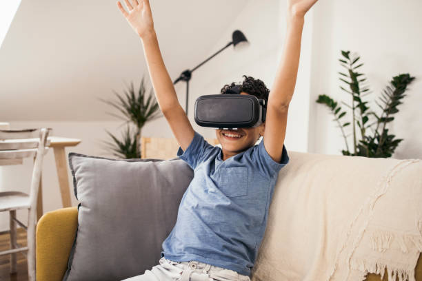 istock Portrait of a boy playing games using virtual reality glasses 1338704861
