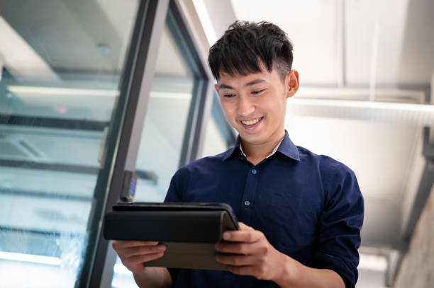 istock Young smiling Asian entrepreneur in modern office 1338705715