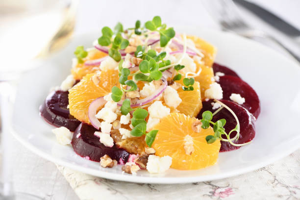 istock Orange salad with baked beetroot, goat cheese, microgreens and nuts. Perfect as a side dish or as a light lunch for a brunch or dinner. 1338705825