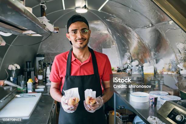 Gloved Young Man In Uniform Holding Fast Food Stock Photo - Download Image Now - Fast Food Restaurant, Employee, Selling