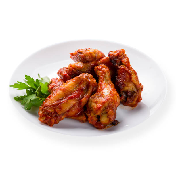istock chicken wings in barbecue sauce on white plate isolated on white background side view 1338709053