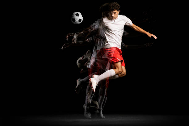 istock Stroboscope effect. One man, professional football player isolated on black background playing 1338709115