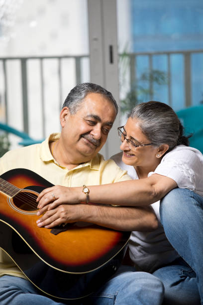 istock Couple having fun playing guitar at home 1338710869