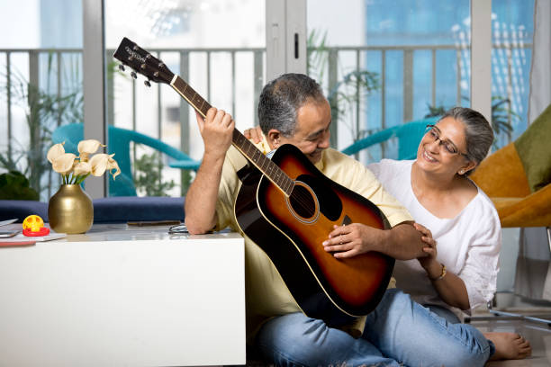 istock Couple having fun playing guitar at home 1338711487