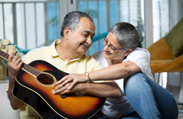 istock Couple having fun playing guitar at home 1338711501
