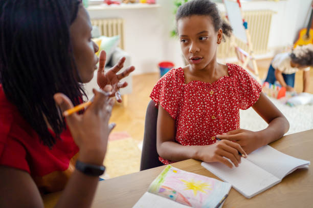 istock Mother with daughter sitting and making homework 1338713039