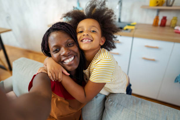 istock Mother with child taking selfie at home 1338713315