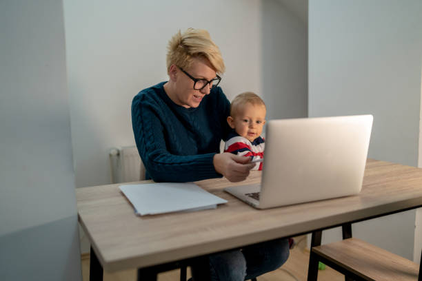 istock Mother and son at home, having fun together, using laptop. 1338713713