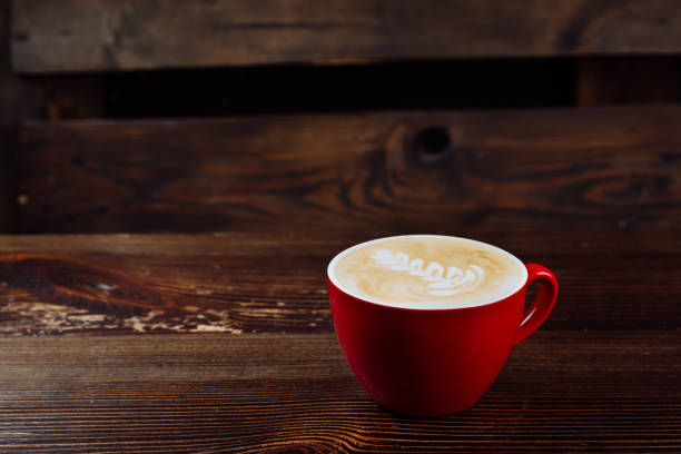 istock Fresh coffee with latte art in red cup 1338714564