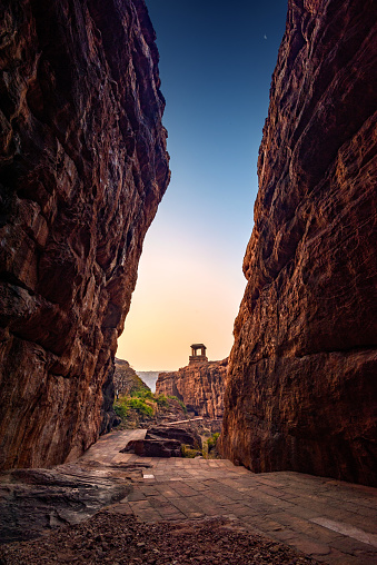 Path through steep cliffs, Entrance for lower and upper Shivalaya in Badami, Karnataka, INDIA. Passageway through rock cliffs.