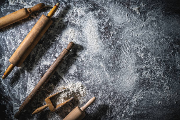 istock Rolling pin and flour serving scoop on flour spread background abstract for bakery themes 1338717894