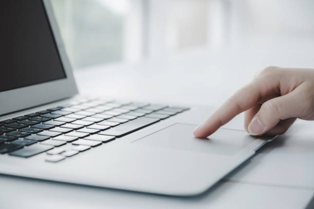 istock closeup hand touching touchpad on laptop computer on desk at home office, work from home, searching web, social network, online, business strategy, finance, investment and digital technology concept 1338717909
