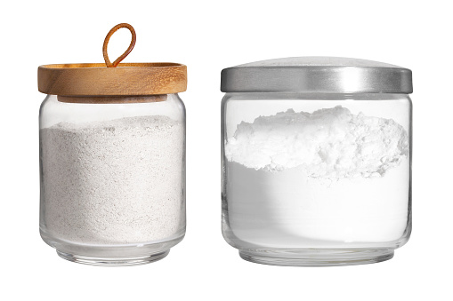 white flour in glass jar isolated on white background