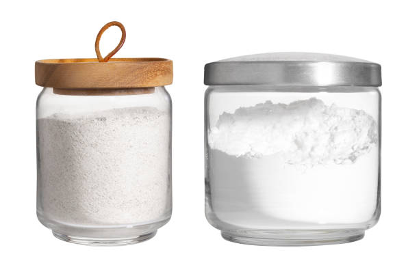 white flour in glass jar isolated on white background stock photo