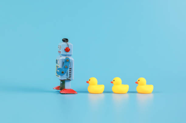 istock vintage retro robot and Yellow Rubber Bath Ducks, leadership concept 1338718960