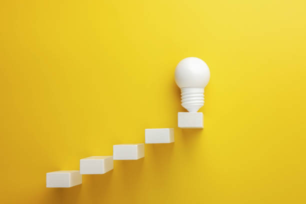 istock rising line graph on wooden cube blocks and light bulb, business concept 1338718974