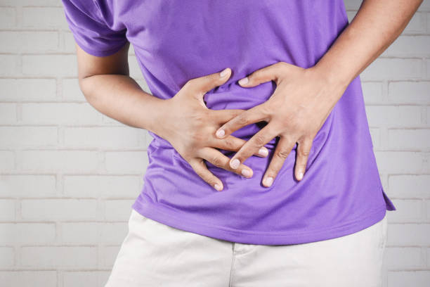 istock young man suffering stomach pain close up. 1338720284
