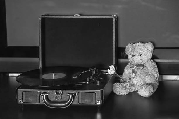 istock Retro teddy bear, vintage gramophone phonograph record player. 1338720474